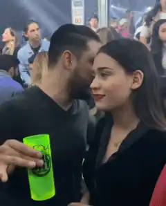 Man whispers to woman in club