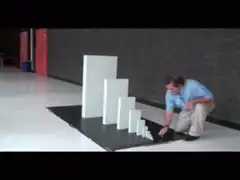 Man pushes dominoes
