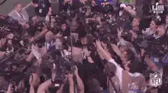 Crowd of reporters swarming a football player