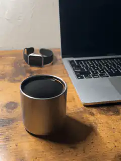 coffee cup on desk with laptop