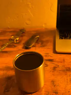 metal cup on wooden desk