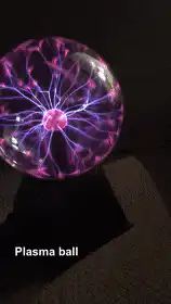 Hand touching plasma ball