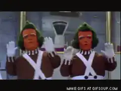 Two green-haired men in brown suits dancing
