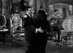 man and woman dancing in parlor