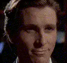 Christian Bale smirking and smiling