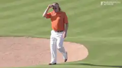 Golfer wipes sweat from forehead