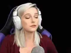 Blonde woman with headphones facepalms