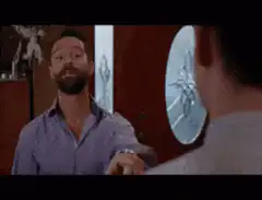 Jesse Williams and Jim Carrey smiling at each other