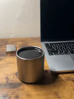 coffee cup next to laptop