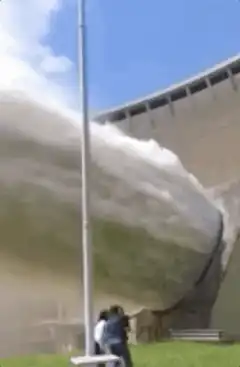 people watching dam spillway release