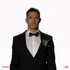 Man in tuxedo pointing down