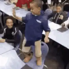 Kid dancing on chair in classroom