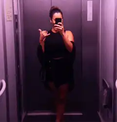 woman in elevator mirror selfie