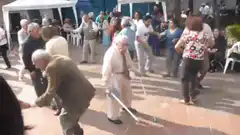 Elderly man dancing with crutches