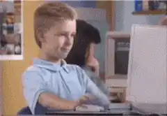 Kid typing on computer gives thumbs up