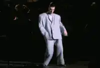 Justin Timberlake dancing in a white suit