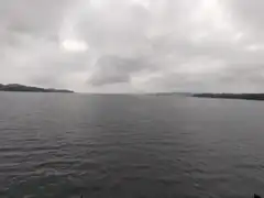 Overcast lake with distant hills