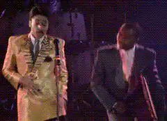 Elton John and Billy Joel dancing on stage