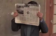 Man lowers newspaper to peek