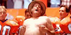 shirtless man in hat cheering