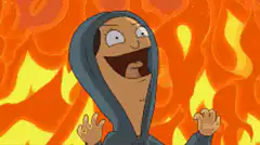 Woman in hoodie laughing in fire