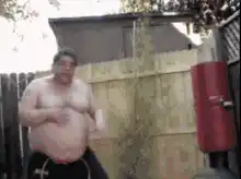 Fat man kicks and hugs punching bag