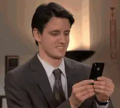 Andy Bernard looking at phone