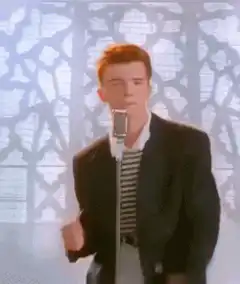 Rick Astley singing into a microphone