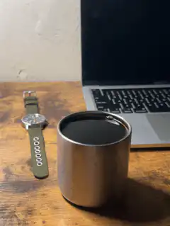 watch and coffee cup on desk