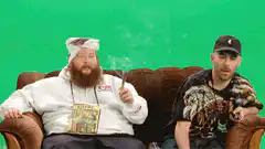 Two men on a couch smoking