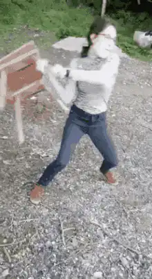 Woman swings axe at wooden target