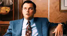 Leonardo DiCaprio coughing in a suit
