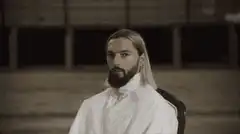 Man in white suit in large hangar
