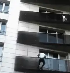 Man parkour climbing building balconies