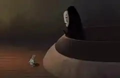 No Face offers gold to the frog