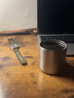 watch and coffee cup on desk