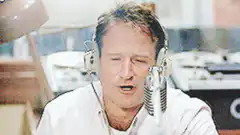 Robin Williams singing into a microphone