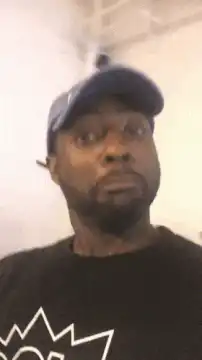 Man in blue hat looks confused as woman appears