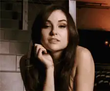Mila Kunis winking and smiling