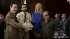 Man in brown suit gestures excitedly in courtroom