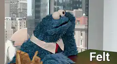 Cookie Monster in a shirt looking bored