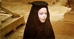 Girl in black hood with glowing blue eyes