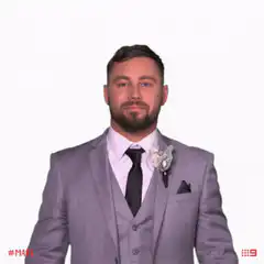 Man in suit covers eyes