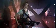 Parker Posey with a large gun