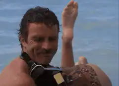 Man carrying woman on his back in the ocean