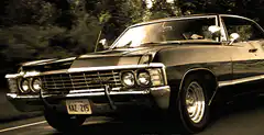 Black Chevrolet Impala driving on road