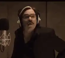 Man in headphones screaming into microphone