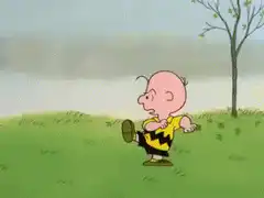 Charlie Brown trips over Lucy