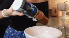 Woman pouring salt into a bowl