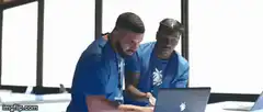 Two men looking at laptop then facepalm